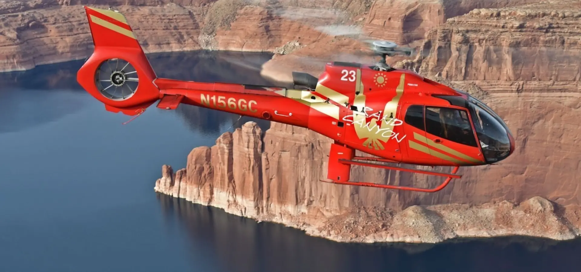 Rs13659 rs9411 pap1 lakemead edit red ec 130 helicopter flying over lake mead