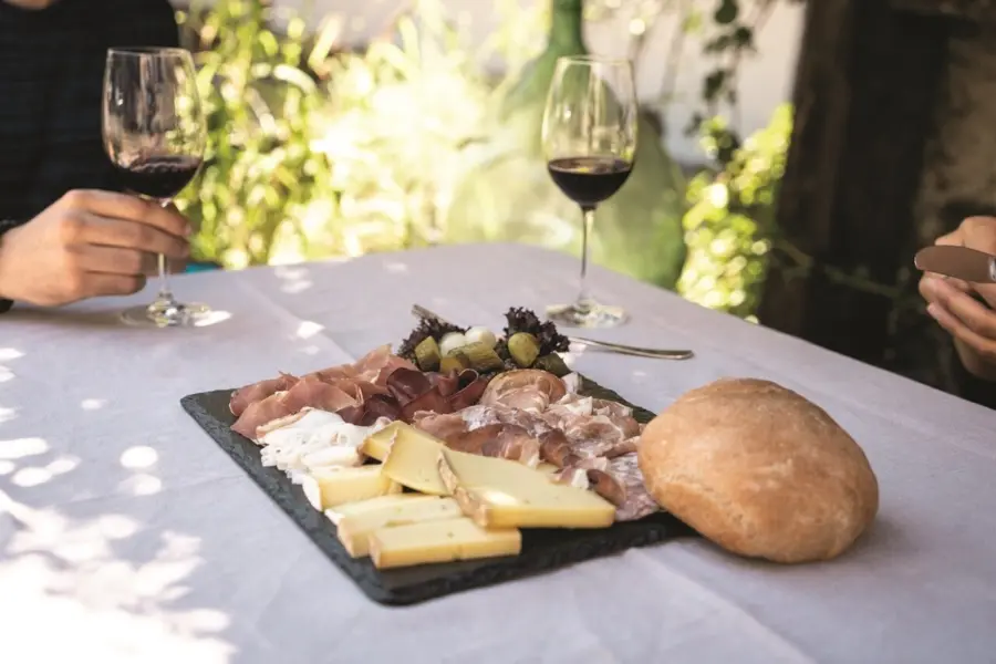 1770827052315switzerland tourismst3x2a plate of meat and cheese and a glass of wine95649