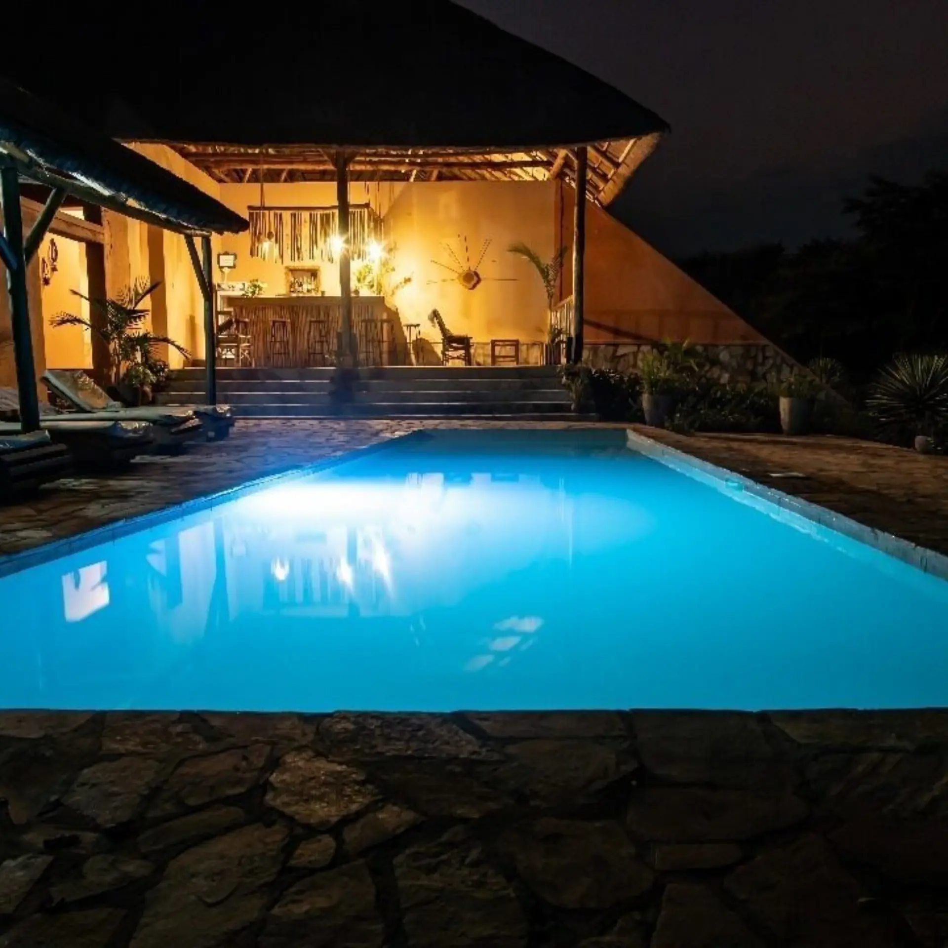 1755273903240pool at night at kikonko lodge