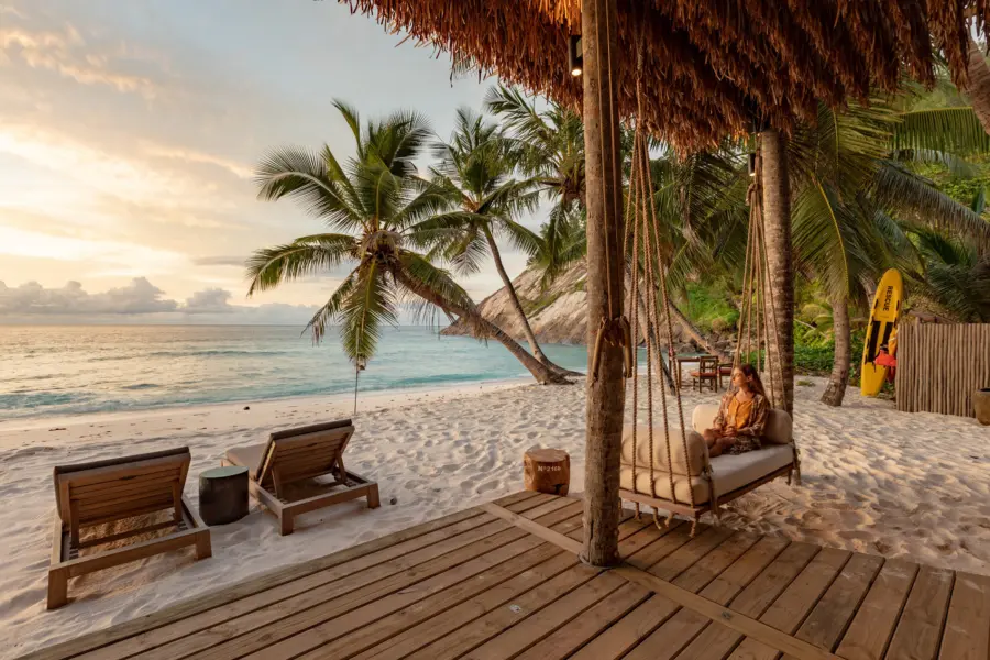 North Island Dining and Cuisine West Beach Bar guest on swing