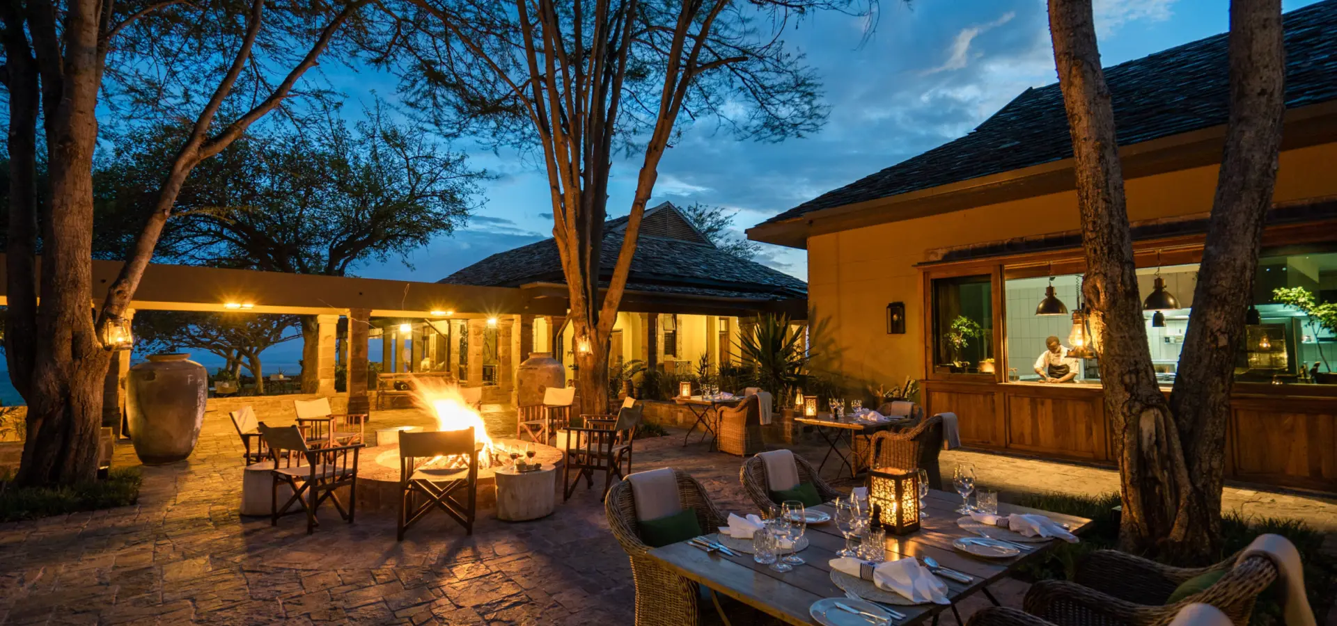 Singita sasakwa lodge outdoor evening dining with fire
