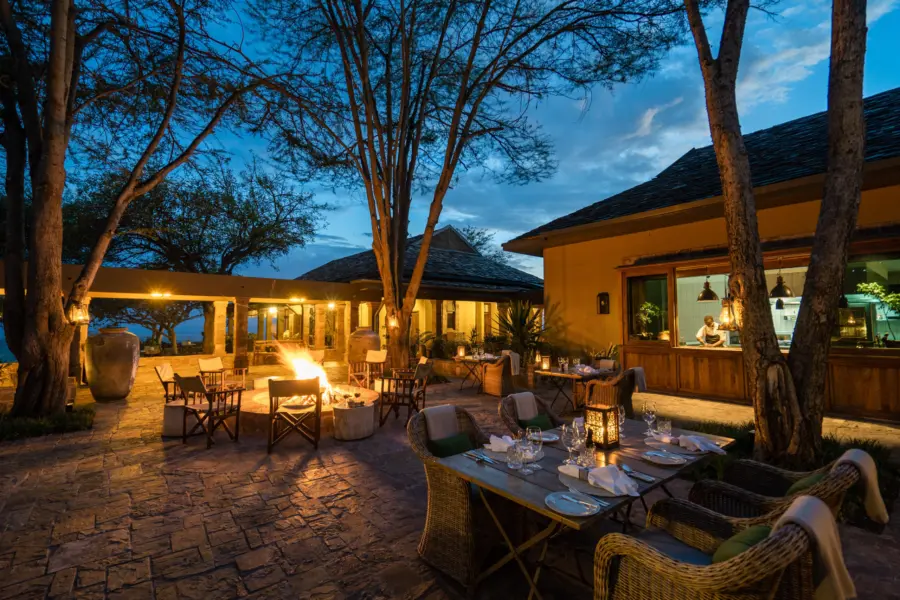 Singita sasakwa lodge outdoor evening dining with fire