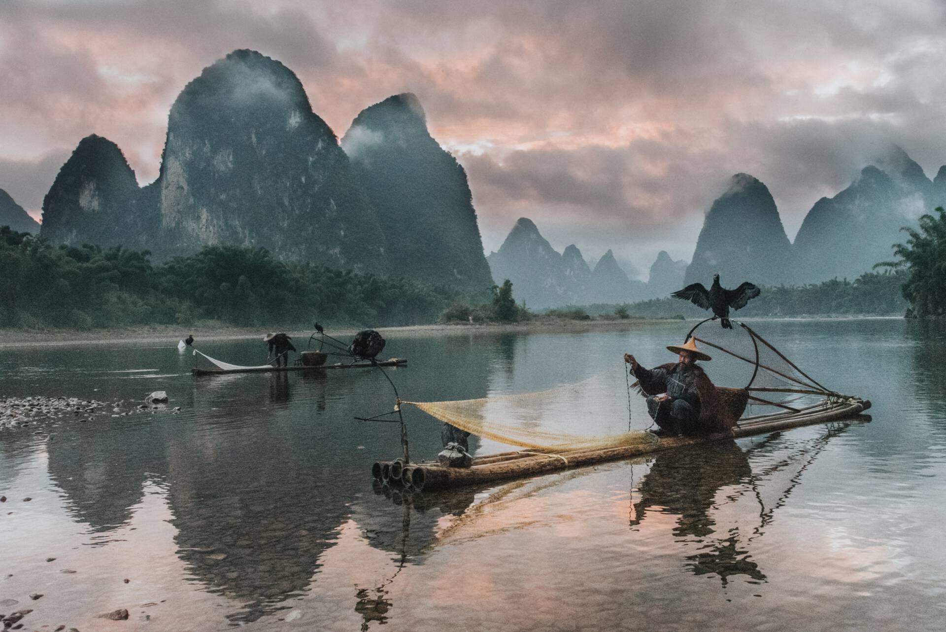 Visser met aalscholver in Zuid-China